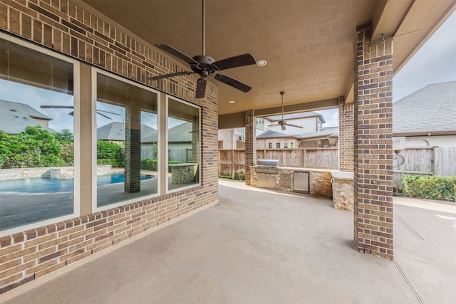 view of patio featuring an outdoor kitchen, area for grilling, and ceiling fan