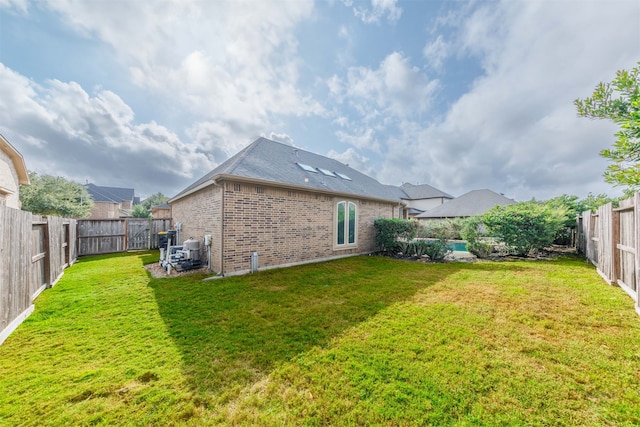 rear view of house featuring a yard