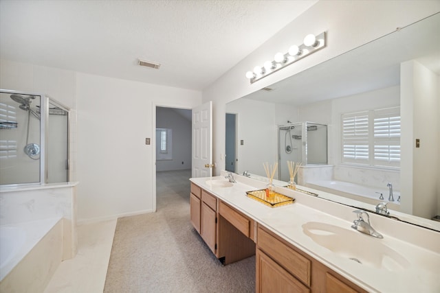 bathroom featuring vanity, independent shower and bath, and a textured ceiling