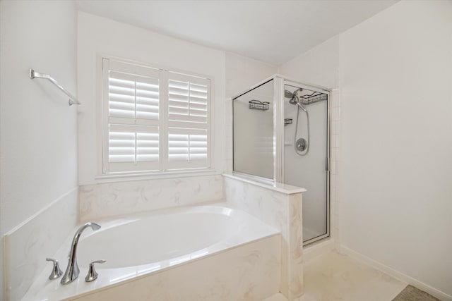 bathroom featuring separate shower and tub