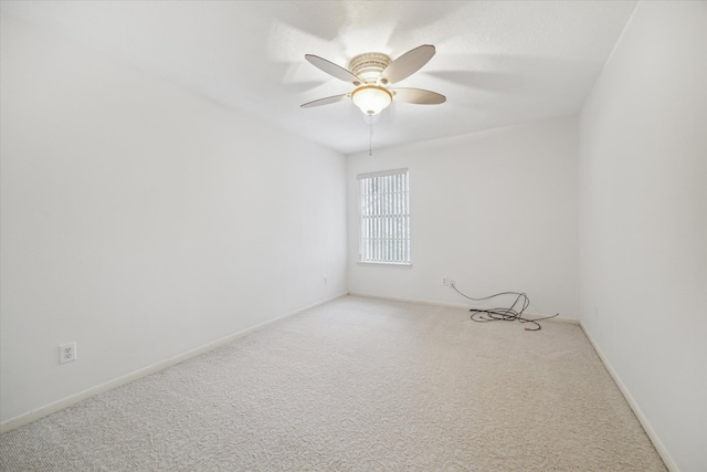 empty room featuring carpet floors and ceiling fan