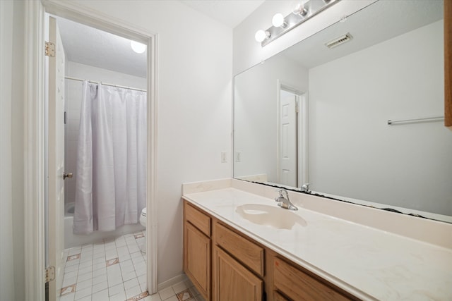 full bathroom featuring vanity, shower / bath combo with shower curtain, toilet, and tile patterned flooring