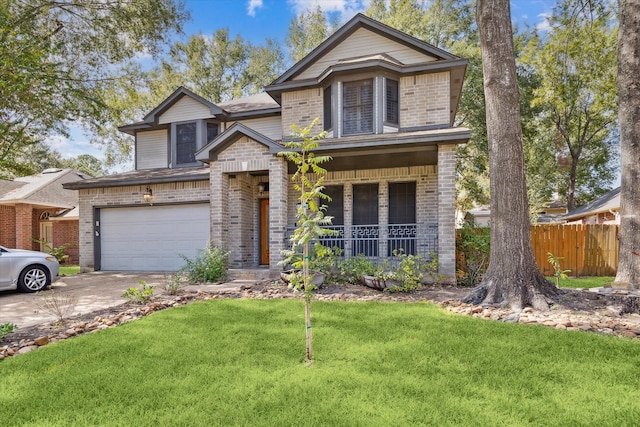 view of front of property featuring a front yard, covered porch, and a garage