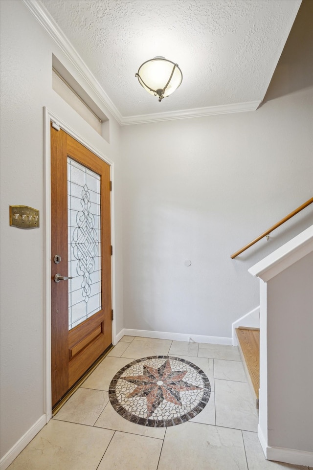 foyer entrance featuring crown molding, a textured ceiling, and light tile patterned flooring