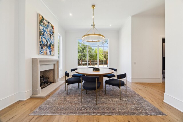 1944 Larchmont Rd, Houston, TX 77019 - dining space with ornamental molding, wood finished floors, baseboards, a chandelier, and a tile fireplace