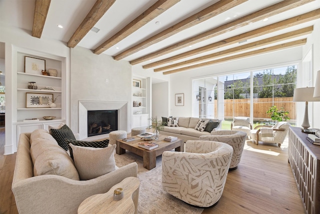 1944 Larchmont Rd, Houston, TX 77019 - living area with built in features, wood finished floors, a premium fireplace, and beamed ceiling