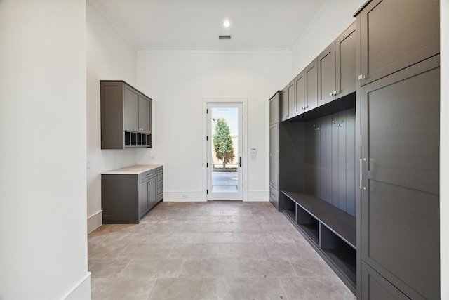 1944 Larchmont Rd, Houston, TX 77019 - mudroom featuring crown molding and baseboards