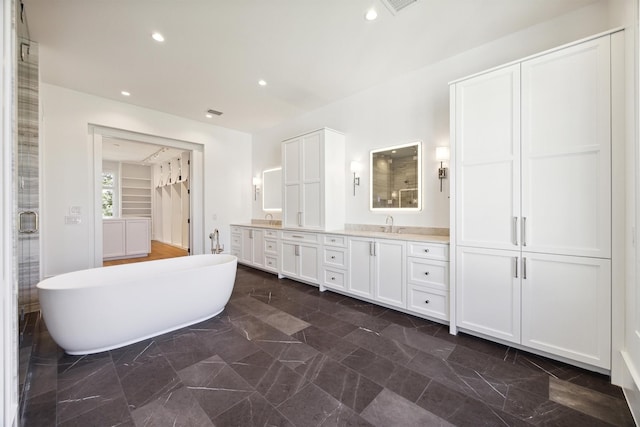 1944 Larchmont Rd, Houston, TX 77019 - full bath featuring double vanity, a soaking tub, marble finish flooring, a shower with door, and recessed lighting