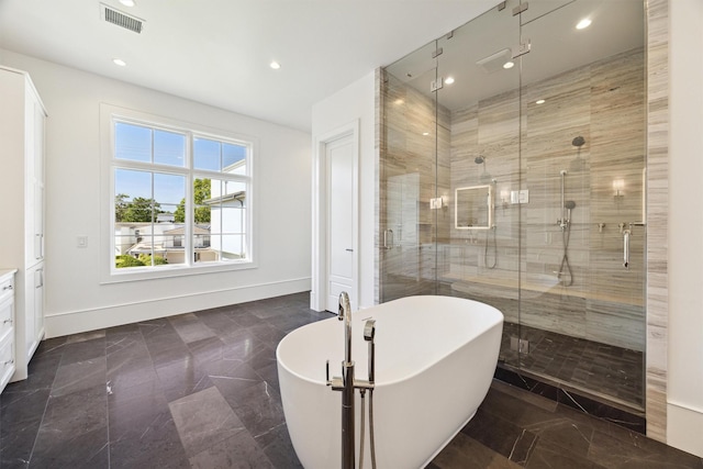 1944 Larchmont Rd, Houston, TX 77019 - bathroom with a shower stall, a freestanding tub, recessed lighting, and baseboards