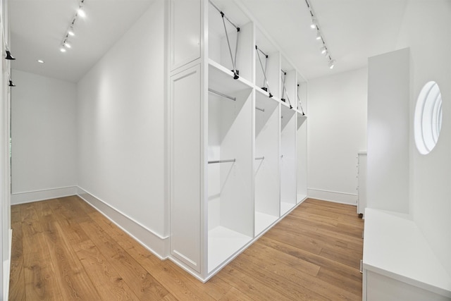 1944 Larchmont Rd, Houston, TX 77019 - hallway featuring track lighting, light wood-style flooring, and baseboards