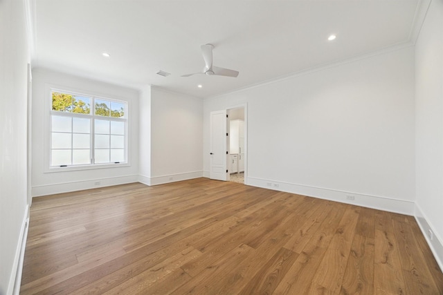 spare room featuring ceiling fan, ornamental molding, and light hardwood / wood-style floors