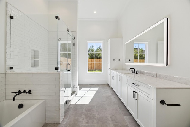 bathroom featuring independent shower and bath, tile patterned flooring, crown molding, and vanity