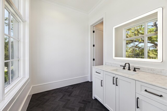 bathroom with ornamental molding and vanity