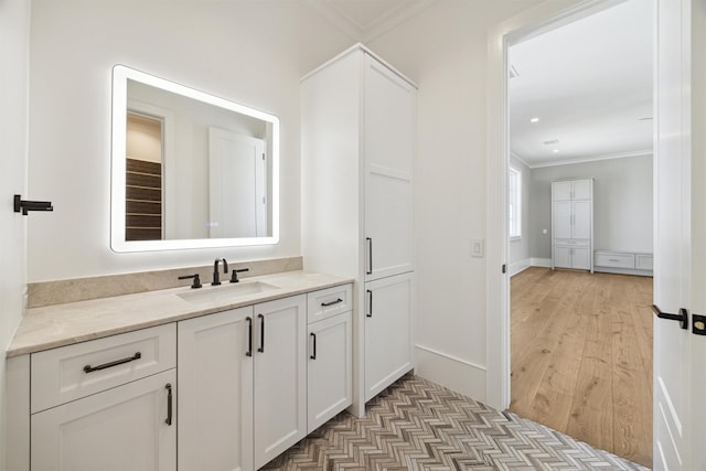 1944 Larchmont Rd, Houston, TX 77019 - bathroom with crown molding, wood finished floors, baseboards, and vanity