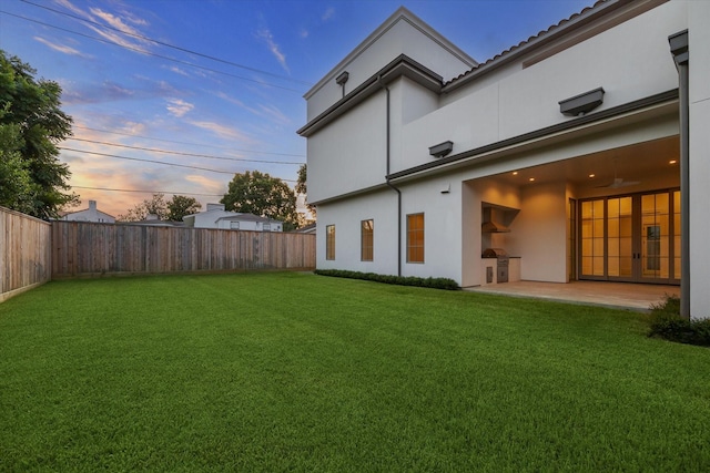 1944 Larchmont Rd, Houston, TX 77019 - back of house featuring stucco siding, a fenced backyard, a patio, and ceiling fan