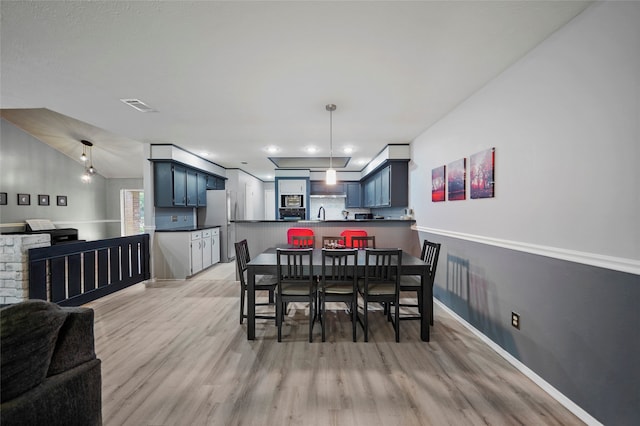 dining space featuring light hardwood / wood-style floors