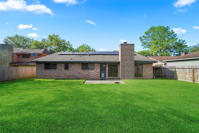 back of house featuring a yard and a patio area