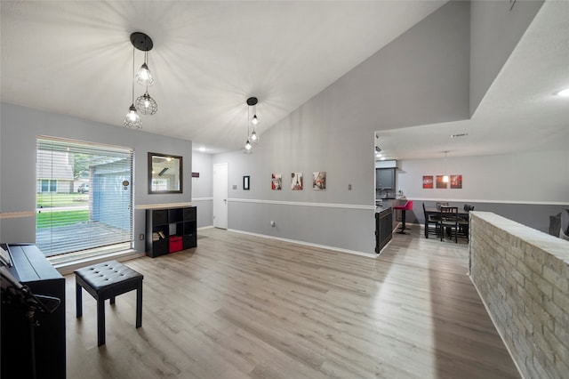 living room featuring high vaulted ceiling and hardwood / wood-style floors