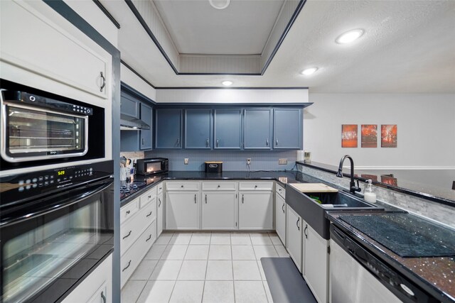 kitchen featuring white cabinetry, black appliances, blue cabinets, and sink