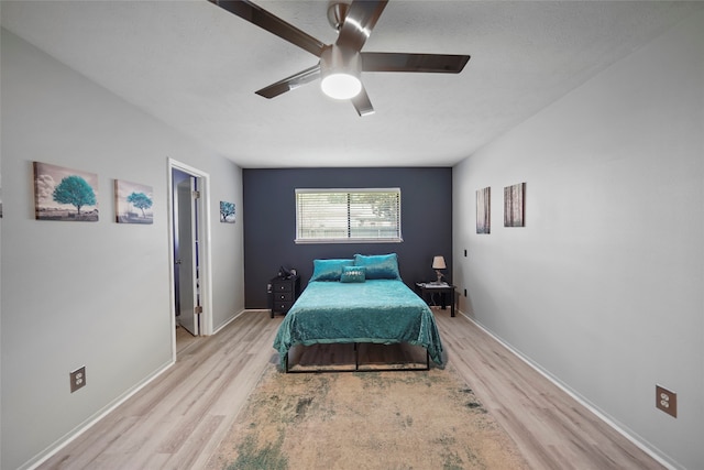 bedroom featuring ceiling fan and light hardwood / wood-style floors