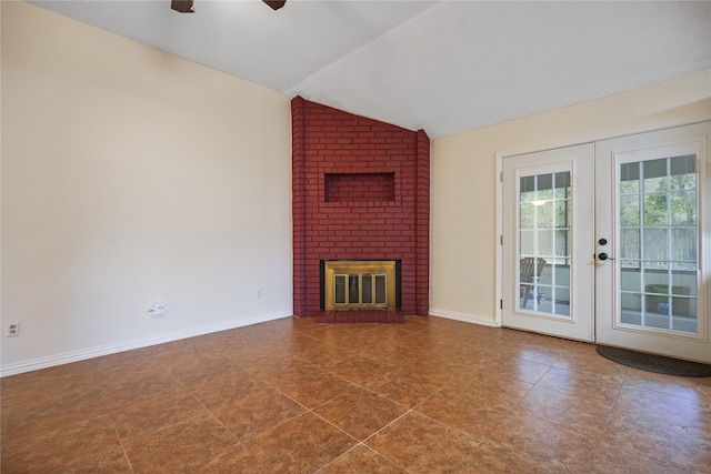 unfurnished living room featuring lofted ceiling, french doors, a fireplace, and ceiling fan