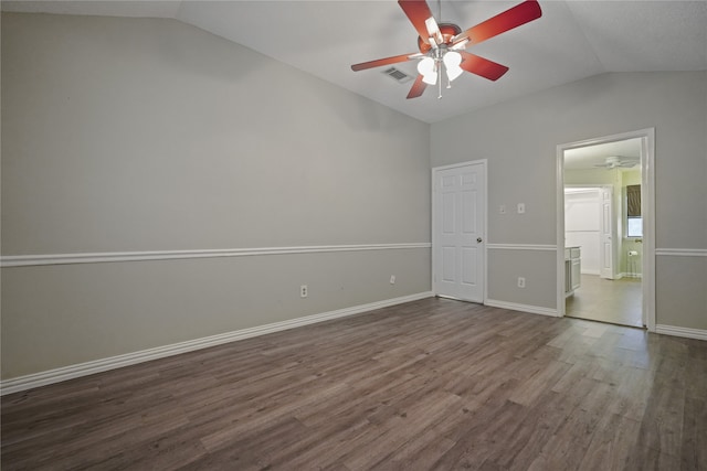 unfurnished bedroom with dark wood-type flooring, vaulted ceiling, and ceiling fan