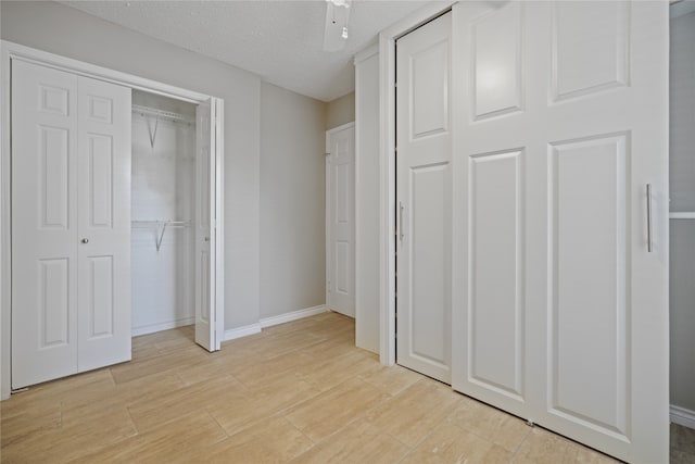 unfurnished bedroom featuring a textured ceiling and ceiling fan