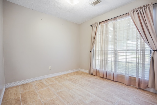 spare room featuring a textured ceiling