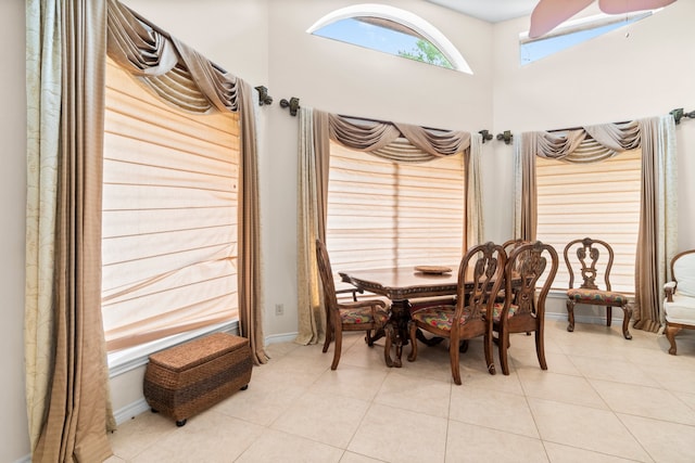 tiled dining area featuring a skylight