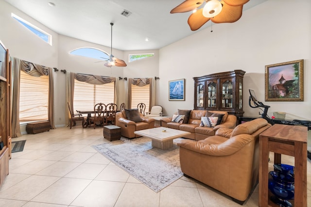 tiled living room featuring high vaulted ceiling and ceiling fan