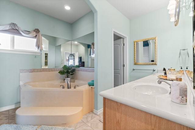 bathroom featuring a bathing tub, vanity, and tile patterned flooring