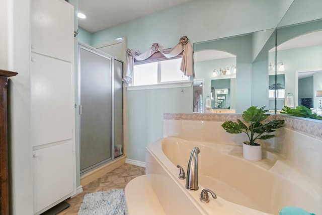 bathroom featuring tile patterned flooring, separate shower and tub, and vanity