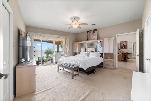 carpeted bedroom featuring ceiling fan and access to exterior