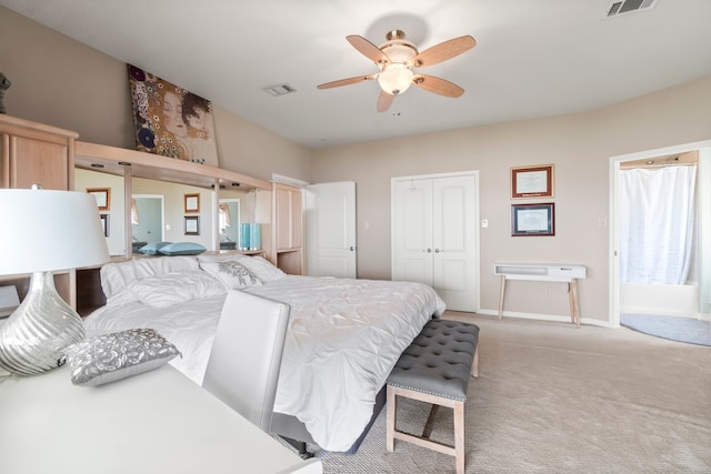 bedroom featuring a closet, light colored carpet, and ceiling fan