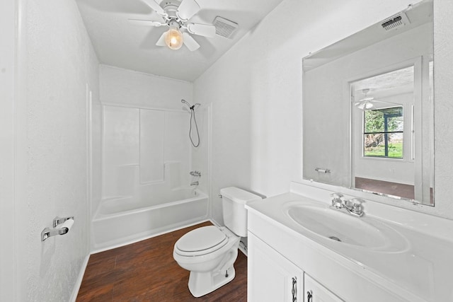 full bathroom with ceiling fan, hardwood / wood-style flooring, toilet, vanity, and shower / bath combination