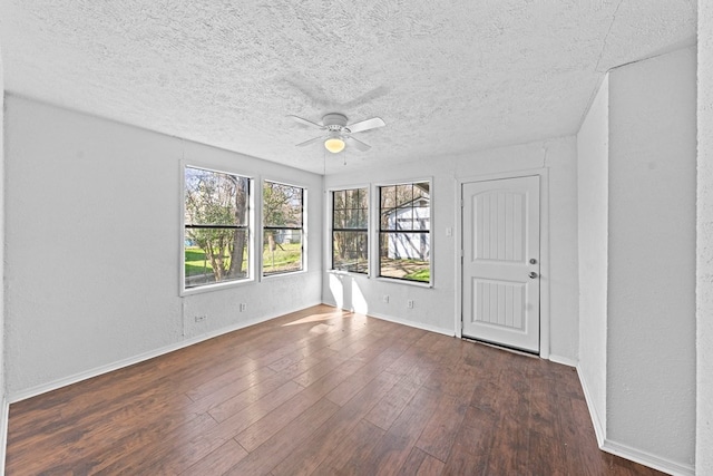 unfurnished room with dark hardwood / wood-style floors, a textured ceiling, and ceiling fan