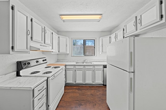 kitchen featuring white appliances, sink, a textured ceiling, white cabinetry, and dark hardwood / wood-style floors