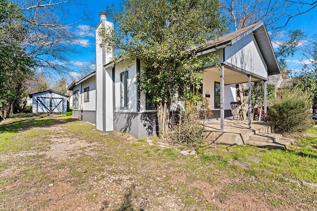 rear view of house featuring a storage shed