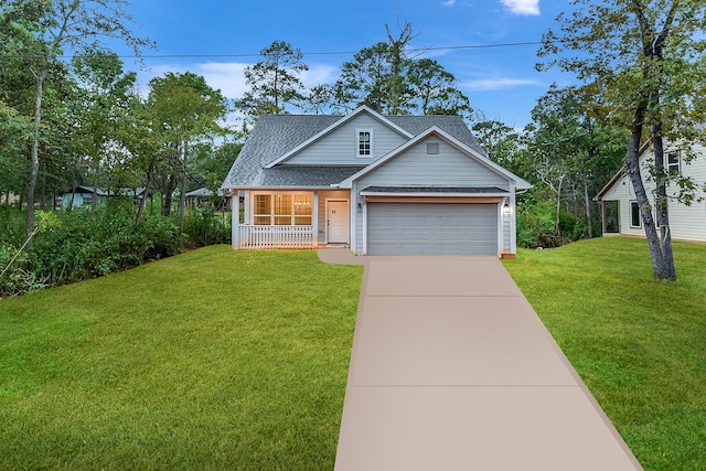 view of front facade with a garage, a front yard, and covered porch