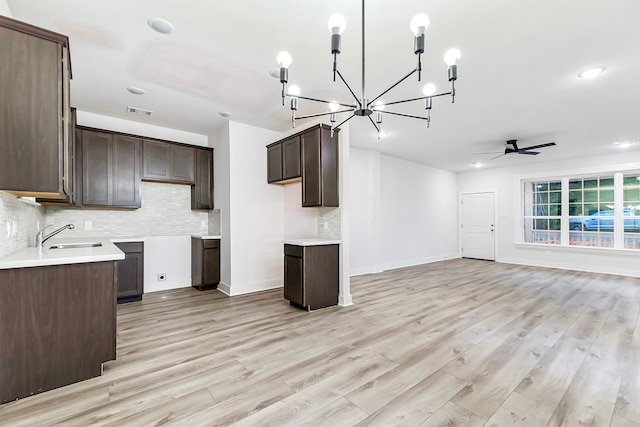 kitchen featuring dark brown cabinets and light wood-type flooring