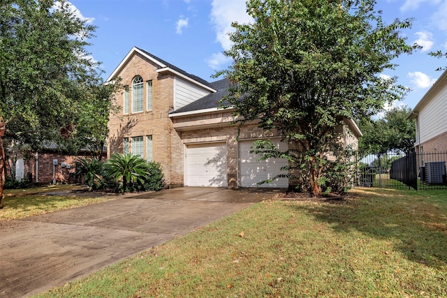 view of front of property with a garage, central AC unit, and a front yard