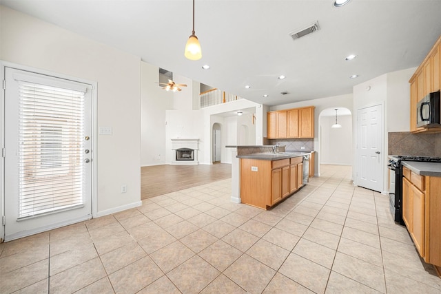 kitchen with pendant lighting, black appliances, ceiling fan, and light tile patterned flooring