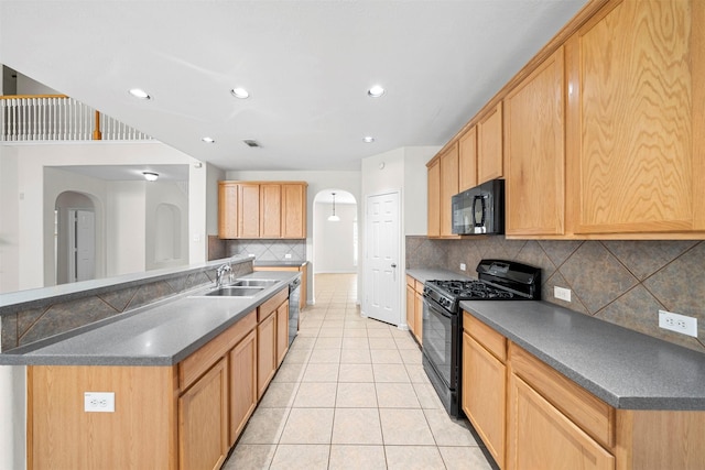 kitchen featuring sink, a center island, light tile patterned floors, black appliances, and light brown cabinets