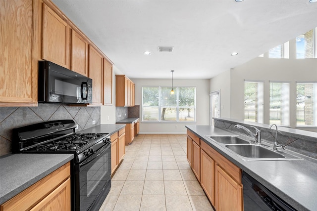 kitchen with pendant lighting, sink, black appliances, light tile patterned flooring, and decorative backsplash