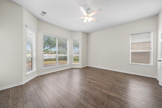 spare room featuring dark hardwood / wood-style floors and ceiling fan