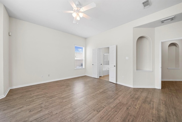 empty room featuring dark hardwood / wood-style flooring and ceiling fan