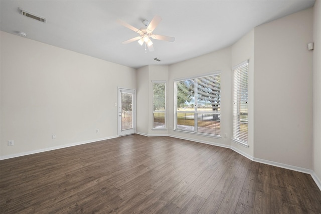 empty room with dark wood-type flooring and ceiling fan