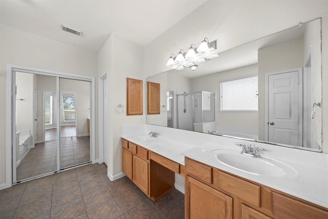 bathroom with vanity, tile patterned floors, and shower with separate bathtub