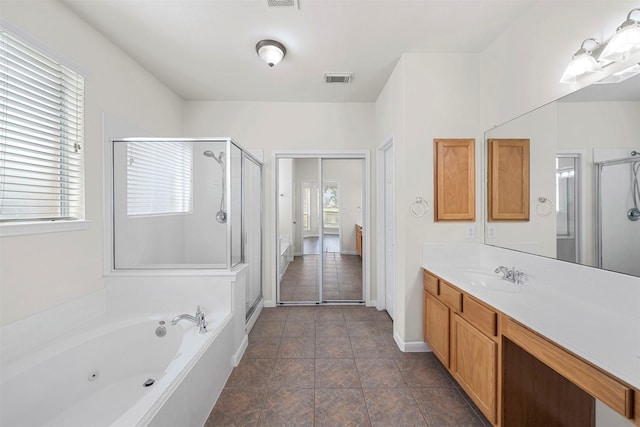 bathroom with vanity, plus walk in shower, and a wealth of natural light