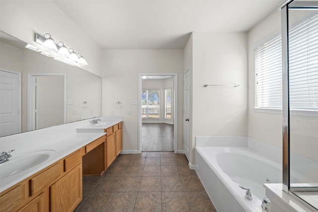 bathroom featuring vanity, a bath, tile patterned flooring, and a wealth of natural light